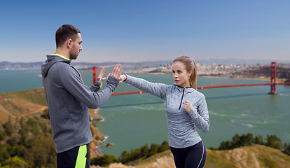 Image showing happy woman with coach working on strike outdoors