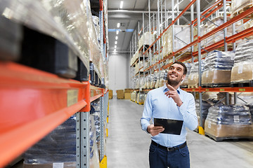 Image showing happy businessman with clipboard at warehouse