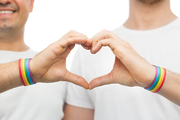 Image showing gay couple with rainbow wristbands and hand heart