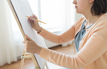 Image showing artist with pencil drawing picture at art studio