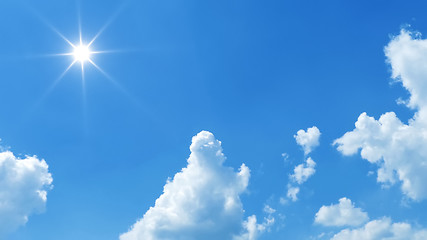 Image showing blue sky with bright sun and white clouds