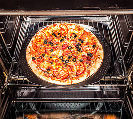 Image showing Appetizing pizza in the oven.