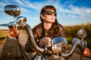 Image showing Biker girl sitting on motorcycle