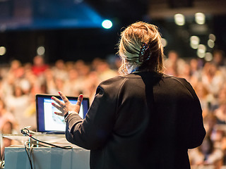 Image showing Female public speaker giving talk at Business Event.