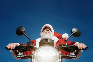 Image showing man on a motorbike in a typical Santa Claus costume