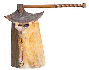 Image showing The old rusty ax of the executioner on a wooden stump isolated o