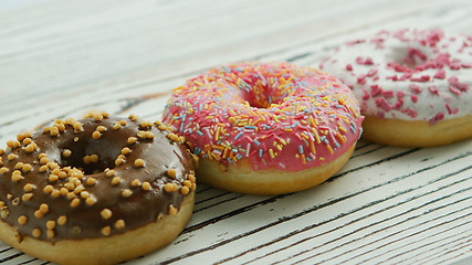 Image showing Row of sweet glazed doughnuts