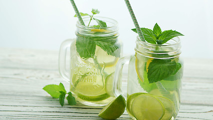 Image showing Glass jars filled with refreshing lemonade