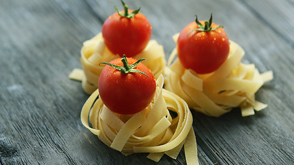 Image showing Bunches of pasta with wet tomatoes