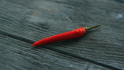 Image showing Single red chili pepper on table