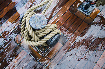 Image showing Bollard with a rope on the wooden deck of a sailing vessel, clos
