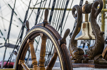 Image showing Ship\'s Bell and wheel the old sailboat, close-up 