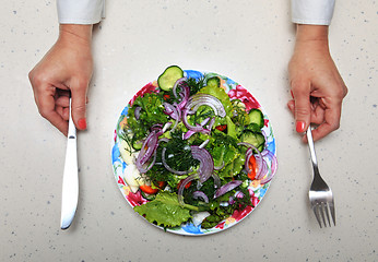 Image showing healthy lunch and hands with kitchen flatware 