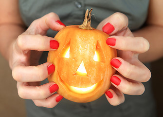 Image showing small yellow pumpkin in hands