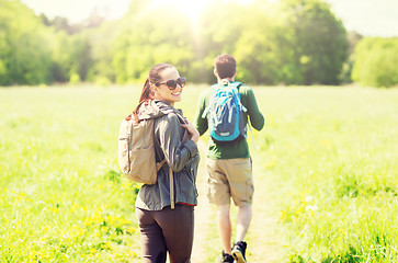 Image showing happy couple with backpacks hiking outdoors