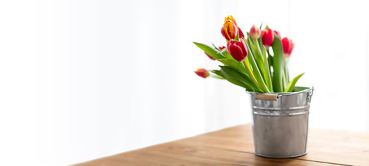 Image showing red tulip flowers on table