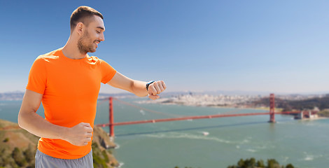 Image showing man with fitness tracker over golden gate bridge