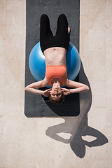 Image showing woman doing exercise with pilates ball top view