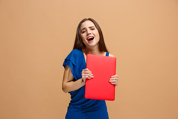 Image showing Businesswoman with laptop on pastel studio