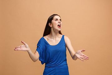 Image showing The young emotional angry woman screaming on pastel studio background