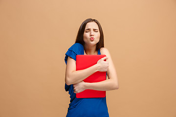 Image showing Businesswoman hugging laptop on pastel studio