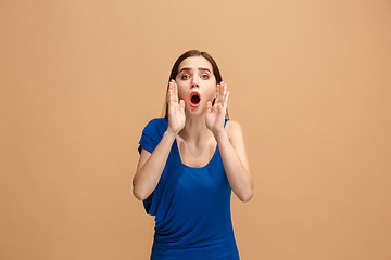 Image showing Isolated on pastel young casual woman shouting at studio