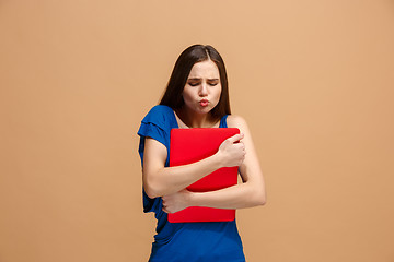 Image showing Businesswoman hugging laptop on pastel studio