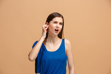 Image showing The Ear ache. The sad woman with headache or pain on a pastel studio background.