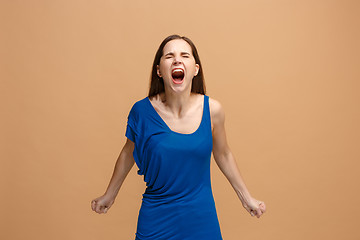 Image showing The young emotional angry woman screaming on pastel studio background