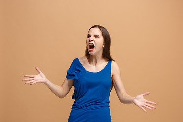 Image showing The young emotional angry woman screaming on pastel studio background