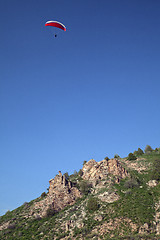 Image showing Parasailing in a blue sky