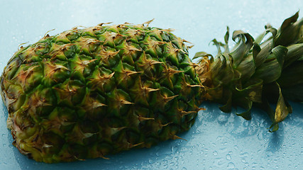 Image showing Half of pineapple on wooden table 