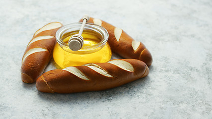 Image showing Baguettes with jar of honey