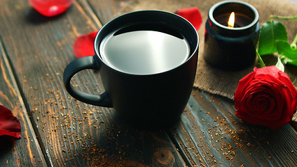 Image showing Mug of drink and red roses