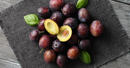 Image showing Served ripe plums on napkin