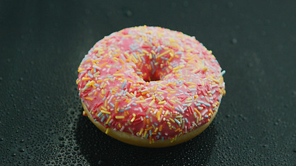 Image showing Pink donut with sprinkles 