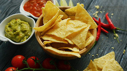 Image showing Nachos and sauces on table 