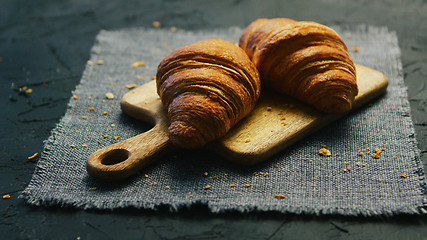 Image showing Fresh croissants on chopping board