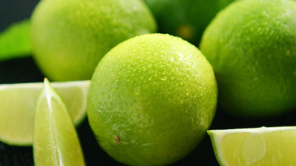 Image showing Bright limes with water drops 