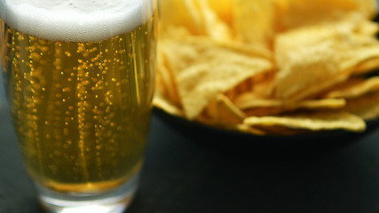 Image showing Glass of beer and nacho chips