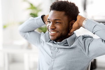 Image showing smiling african american businessman at office