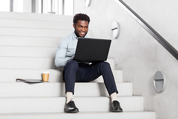 Image showing african american businessman with laptop at office