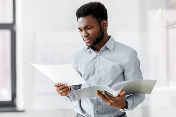 Image showing african american businessman with folder at office