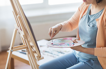 Image showing artist with palette knife painting at art studio