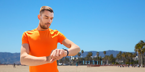 Image showing man with fitness tracker training outdoors
