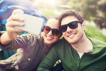 Image showing couple of travelers taking selfie by smartphone