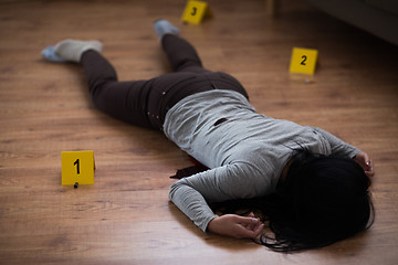 Image showing dead woman body in blood on floor at crime scene