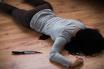 Image showing dead woman body lying on floor at crime scene