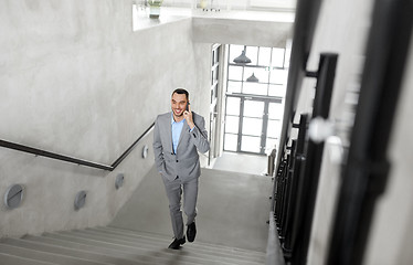 Image showing businessman calling on smartphone at office