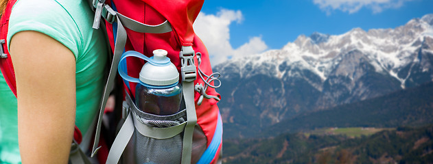 Image showing close up of woman with water bottle in backpack